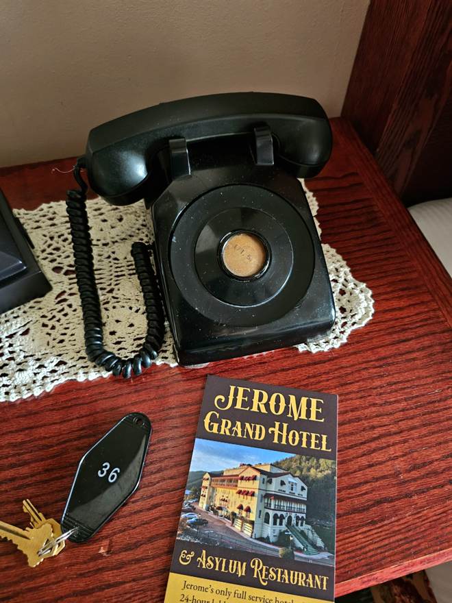 Room 36 key, antique phone, and Jerome Grand Hotel book
